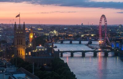 Big Ben and the London Eye at Dusk An elevated dusk view over central London, with Big Ben and the Palace of Westminster on the left and the London Eye glowing beside the River Thames on the...