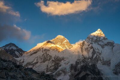 Mount Everest and Nuptse in Golden Evening Light Nepal The final golden sunlight illuminates Mount Everest and the towering summit of Nuptse above Nepal's Khumbu Valley. Photographed from Kala Patthar, the...