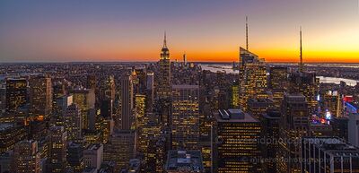 Midtown Manhattan Skyline at Sunset from Top of the Rock The Midtown Manhattan skyline glows beneath a brilliant orange and golden sunset, photographed from the Top of the Rock observation deck at Rockefeller Center...