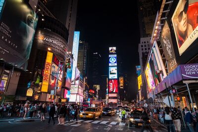 Times Square at Night New York City Lights and Street Life The electric atmosphere of Times Square comes alive at night in Midtown Manhattan, New York City. Towering illuminated billboards, colorful Broadway...