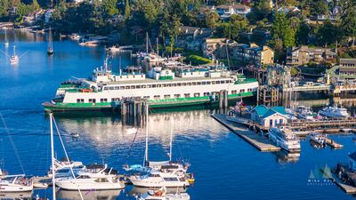 Washington State Ferry at Friday Harbor on San Juan Island A Washington State Ferry sits at the Friday Harbor terminal surrounded by sailboats, marinas, waterfront homes, and the deep blue waters of the San Juan...