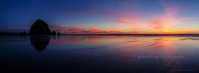 Cannon Beach Sunset Reflections and Haystack Rock A broad wash of pink, orange, and blue evening color reflects across the wet sand at Cannon Beach, Oregon, with Haystack Rock silhouetted at the edge of the...