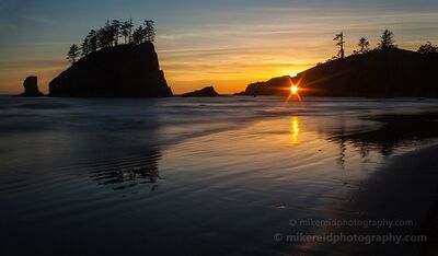 Second Beach Sunset Tranquility The setting sun aligns with the Hole in the Wall at Second Beach on Washington’s Olympic Coast, creating a bright sunstar between the dark coastal rocks. Golden...