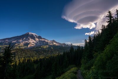 Lenticular Vortex Cloud at Dawn over Mount Rainier At dawn, a massive lenticular vortex cloud swirls above Mount Rainier, its layered form glowing softly in the first light of morning. The mountain’s rugged...