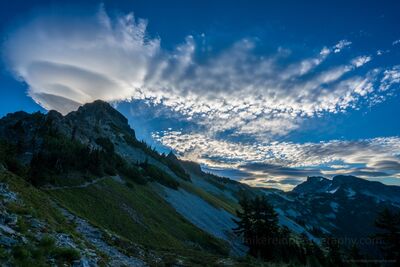 Lenticular Cloud Over Pinnacle Peak – Mount Rainier National Park A mesmerizing lenticular cloud hovers above Pinnacle Peak in Mount Rainier National Park, its layered form catching the morning light against a vivid alpine...