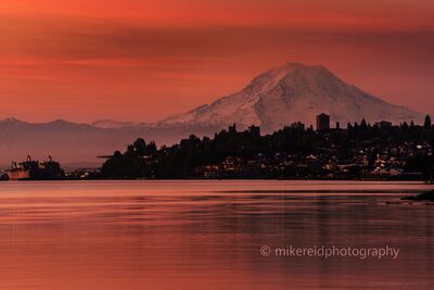 Tacoma Sunset with Mount Rainier from Point Defiance Park A brilliant sunset over Tacoma glows in deep shades of red and gold as Mount Rainier rises majestically beyond the city skyline. Captured from Point Defiance...