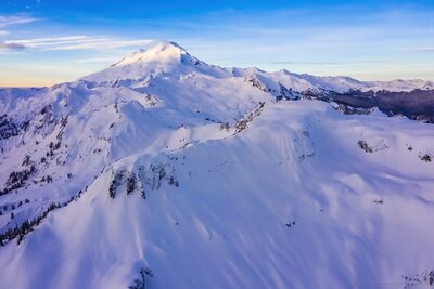 Northwest Aerial — Mount Baker and Table Mountain in Winter Light A breathtaking aerial photograph of Mount Baker and Table Mountain blanketed in pristine winter snow. The soft morning light highlights the mountain’s sculpted...