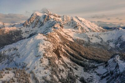 Northwest Aerial Photography Mount Shuksan Arm An aerial perspective of Mount Shuksan and the rugged sweep of Shuksan Arm glowing in warm afternoon light. Captured from high above the North Cascades, this...
