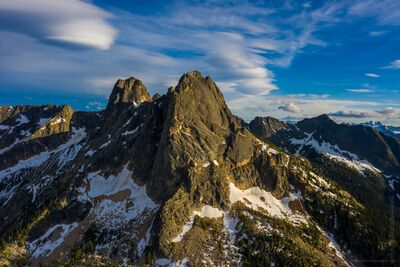 Northwest Aerial Photography North Cascades Liberty Bell Clouds.jpg Dramatic lenticular clouds form above Liberty Bell and Early Winters Spires in Washington’s North Cascades, creating layered shapes across a deep blue sky. Seen...