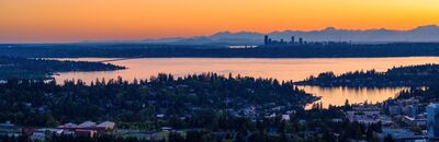 Seattle Skyline and Olympic Mountains Across Lake Washington at Sunset A panoramic aerial view from Bellevue, Washington, looking west across the shimmering waters of Lake Washington toward downtown Seattle and the Olympic...