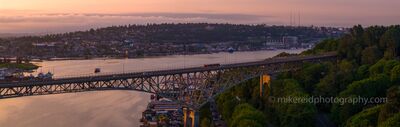 Aurora Bridge at Sunrise with Eastlake and Capitol Hill Aerial sunrise view of Seattle’s Aurora Bridge spanning the Lake Washington Ship Canal, with Eastlake and Capitol Hill layered across the background. Warm early...