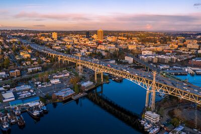 I-5 Ship Canal Bridge and University District at Sunset Aerial evening view over Seattle’s Lake Washington Ship Canal with the I-5 Ship Canal Bridge sweeping across the foreground and the University District beyond....