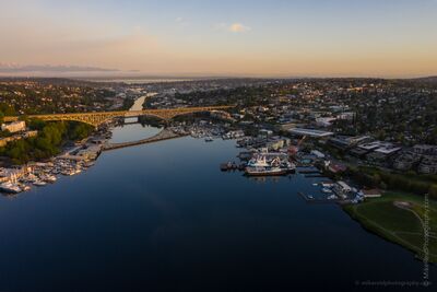 Aurora Bridge Over Lake Union at Sunrise A peaceful aerial sunrise view over Seattle’s Lake Union and the Aurora Bridge, with Queen Anne Hill on the left, Fremont in the center, and Wallingford...