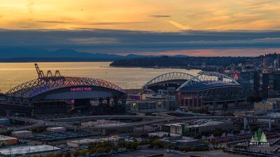 T-Mobile Park and Lumen Field at Sunset, Seattle An aerial view of T-Mobile Park and Lumen Field in Seattle’s SoDo district beneath a colorful Pacific Northwest sunset. The city’s two major sports stadiums sit...