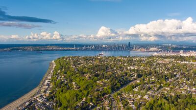 West Seattle and Downtown Seattle Across Elliott Bay An aerial view over West Seattle looking across Elliott Bay toward the downtown Seattle skyline. Residential neighborhoods, green hills, the waterfront, and the...