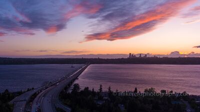 Interstate 90 Floating Bridge at Sunset, Seattle An aerial view of Interstate 90 crossing Lake Washington between Mercer Island and Seattle beneath a colorful Pacific Northwest sunset. The floating bridge...