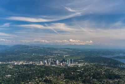 Bellevue Washington Skyline Aerial – Pacific Northwest Cityscape Photography A sweeping aerial view of downtown Bellevue, Washington, surrounded by the forests and lakes of the Pacific Northwest. The city’s modern skyline stands against...