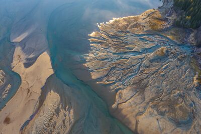 Northwest Aerial Photography River Abstracts .jpg An aerial view of braided river channels and sediment patterns flowing into Baker Lake in Washington State. Turquoise water winds through pale sand and gravel...