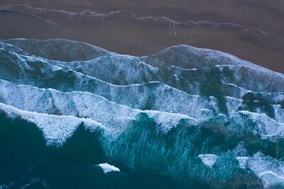Aerial Waves along the Oregon Coast – Cannon Beach Ocean Patterns An artistic aerial view capturing the rhythmic waves along Oregon’s Cannon Beach. The ocean forms abstract layers of teal and white, revealing the natural...
