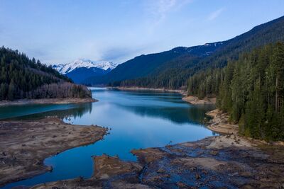 Baker Lake Washington Aerial – North Cascades Reflections and Mountain Landscape A serene aerial view over Baker Lake in Washington’s North Cascades, with calm turquoise waters reflecting snow-covered peaks and evergreen forests. Captured by...