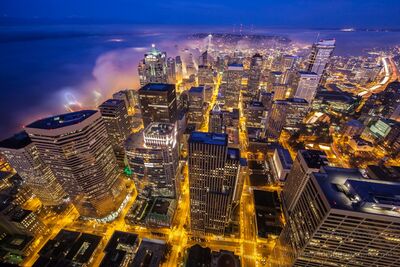 Seattle Urban Dreamscape in Fog from Columbia Center A dreamlike nighttime view over downtown Seattle as fog rolls in from Elliott Bay and curls between the city towers. Photographed from the Columbia Center Sky...