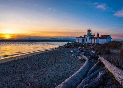 Seattle Photography Discovery Park Lighthouse The golden glow of sunset washes over Discovery Park Lighthouse, one of Seattle’s most peaceful coastal landmarks. Driftwood lines the quiet beach as soft waves...