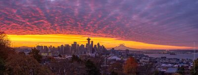 Seattle Kerry Park Photography Sunrise Colors Curve Panorama A breathtaking panorama of Seattle bathed in fall light as a vast carpet of sunrise clouds stretches across the sky. Note the Mount Rainier sunrise shadow. The...