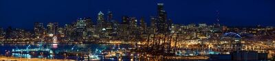 Seattle From West Seattle Night Pano The Seattle skyline sparkles under deep blue night skies in this captivating view from West Seattle. City lights shimmer across Elliott Bay, blending urban...