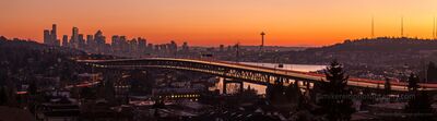 Seattle Sunset Interstate Bridge Arc of Light Wider.jpg A glowing Seattle sunset paints the sky orange and gold as streaks of headlights and taillights trace graceful lines across the Interstate 5 bridge. The Space...