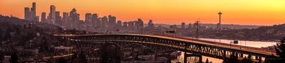 Seattle Golden Sunset Bridge UW Wide Pano.jpg A glowing Seattle sunset paints the sky orange and gold as streaks of headlights and taillights trace graceful lines across the Interstate 5 bridge. The Space...
