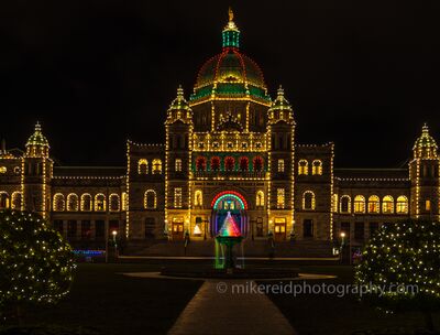 British Columbia Parliament Buildings at Christmas The British Columbia Parliament Buildings glow against the night sky in Victoria, outlined with festive lights and framed by illuminated Christmas trees. Red...