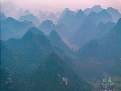 Layers of Karst Mountains at Phong Nam, Northern Vietnam Layers of limestone karst mountains recede into soft morning haze at Phong Nam in Cao Bằng Province, northern Vietnam. The repeating peaks fade from deep green...